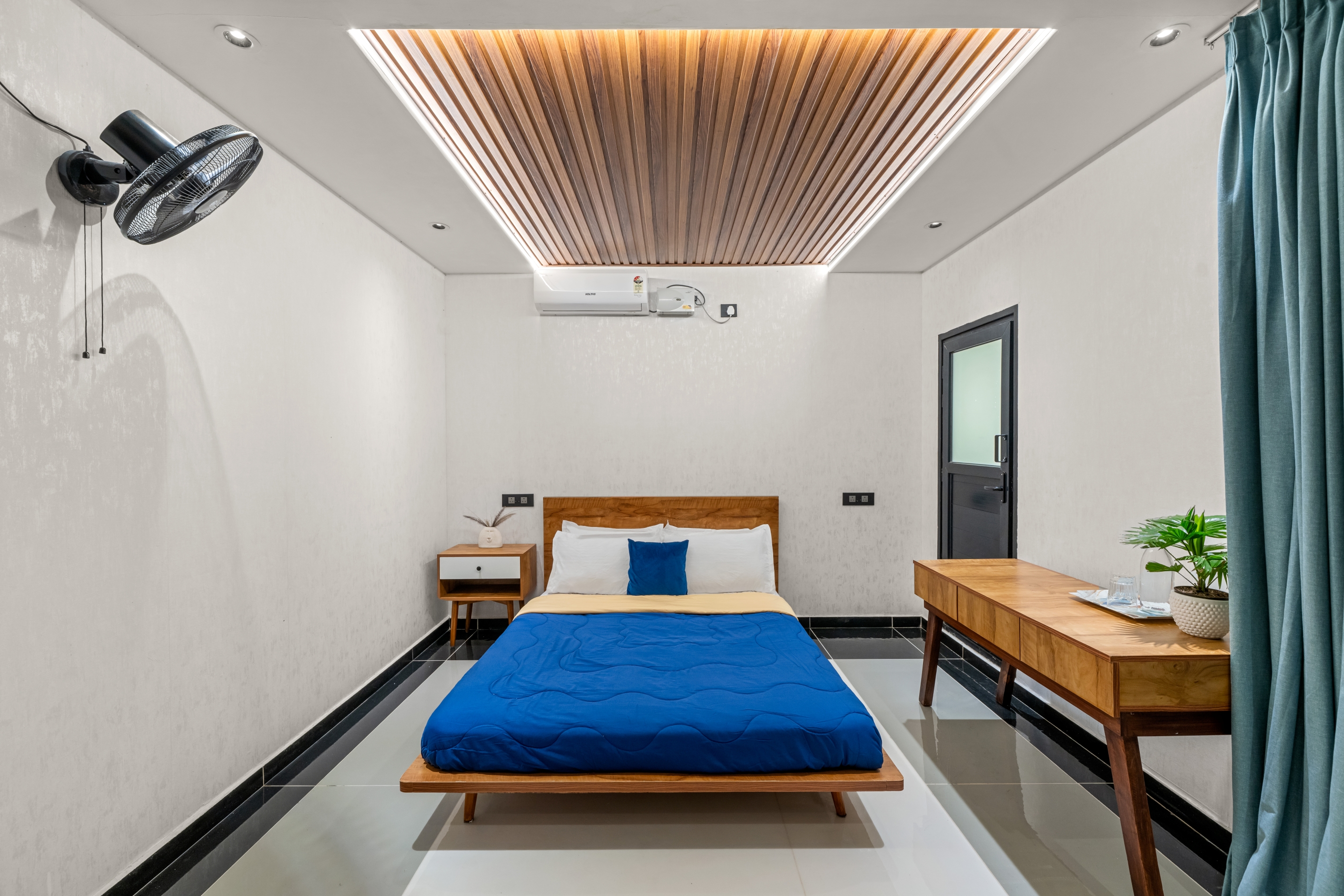 Third bedroom with warm timber ceiling and floor-to-ceiling windows